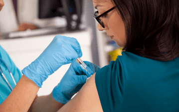 A woman gets a Depo-Provera shot in the arm